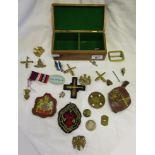 Boxed collection of militaria to include badges, buttons etc