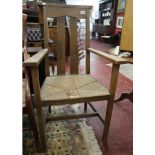 Oak rush seated Arts & Crafts armchair