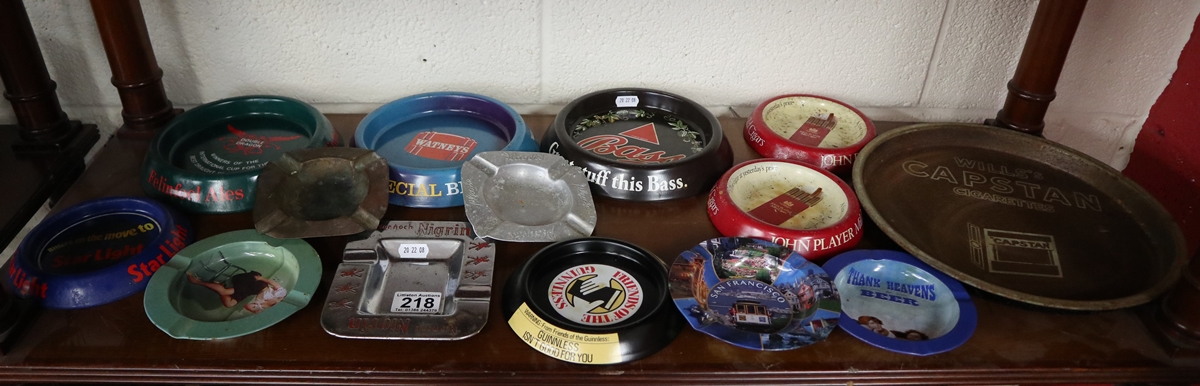 Shelf of pub advertising tin ashtrays