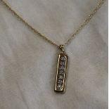 Gold diamond set pendant on gold chain