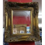 Small bevelled glass mirror with heavy and decorative gilt frame