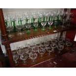 2 shelves of glasses to include set of 32 green stemmed wine glasses