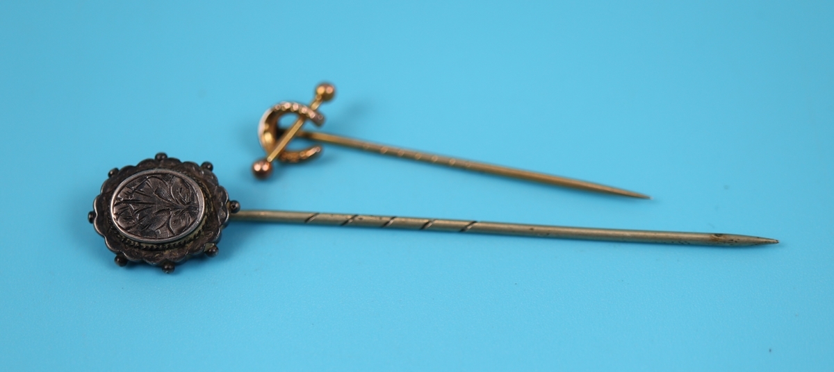 Gold horse shoe stick pin together with Victorian stick pin