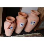 3 graduated terracotta pots