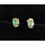 Pair of gold emerald stud earrings