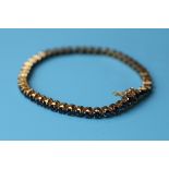 Gold sapphire tennis bracelet with valuation certificate