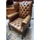 Brown leather wingback armchair