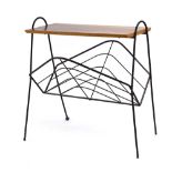 A 1950's magazine rack with metal tubula