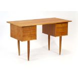 A 1960/70's teak and crossbanded desk wi