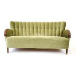 A 1940's green velour sofa with a shell-