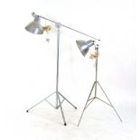 Two vintage photography lights on three-