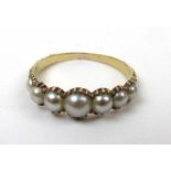 A Victorian yellow metal and pearl ring,