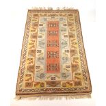 A handwoven Turkish rug, the border surr