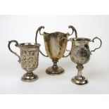 Two silver twin handled cups together wi