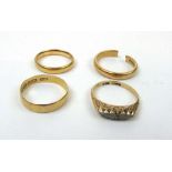Three 22ct gold wedding bands together w