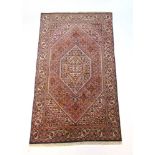 A handwoven Persian rug, the herati bord