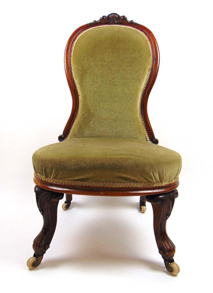 A Victorian walnut nursing chair upholst