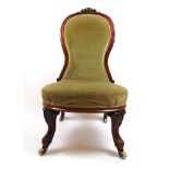 A Victorian walnut nursing chair upholst