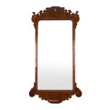 An 18th century walnut fretwork mirror,