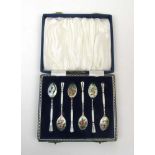 A cased set of six silver and white enam