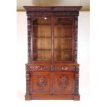 A Victorian carved oak bookcase, the cor