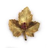 An 18ct gold and ruby brooch in the form