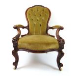 A Victorian walnut open arm chair uphols