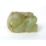 A Chinese carved jade figure of a boy wi