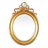 A 19th century giltwood framed oval beve