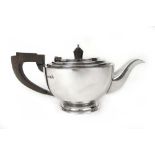 A George V silver teapot of squat form.