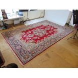 A large handwoven Persian rug. the flora
