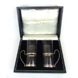 A cased set of two silver mounted glasse