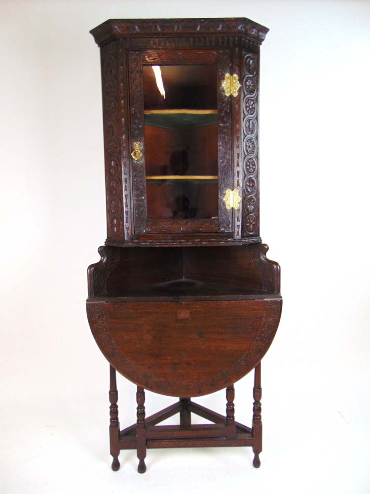 A Victorian carved oak corner cupboard,