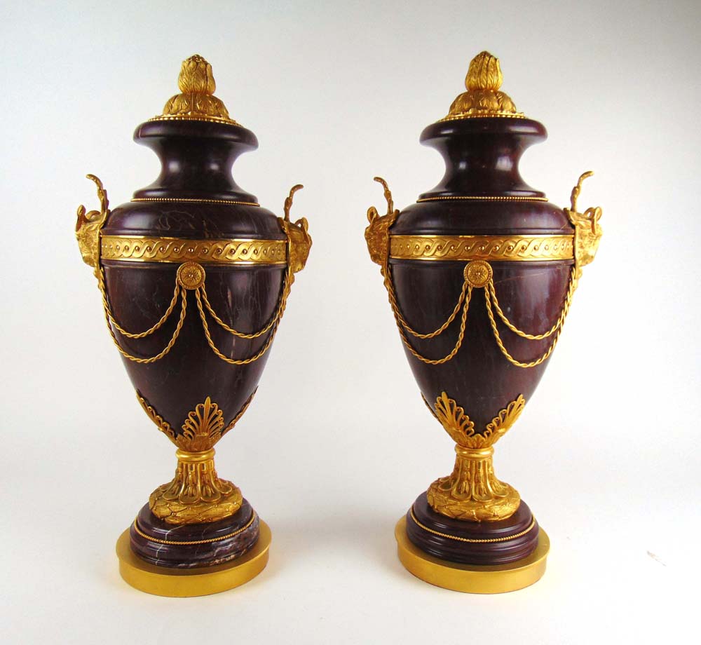 A pair of large red marble and gilt meta
