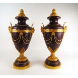 A pair of large red marble and gilt meta