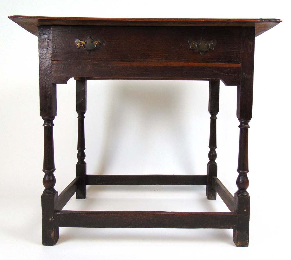 An early 18th century oak lowboy, the mo