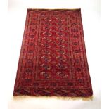 A handwoven Afghan rug, the multi lined