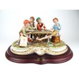 A large Capodimonte figural group of boy