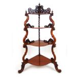 An Edwardian walnut corner what-not, the