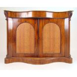 A Victorian rosewood serpentine front chiffonier, the white marble top over two arch panel doors