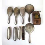 An assortment of silver brushes, mirrors