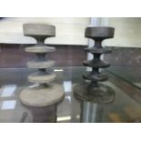 Two cast metal candlesticks in the manne