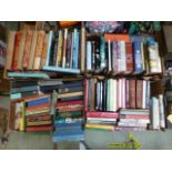 Four trays of assorted hardback books by