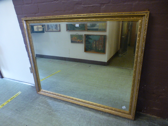 A large rectangular gilt framed bevel gl