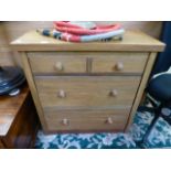 A modern oak chest of two short over two