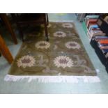A handwoven Himalayan rug, the olive gre