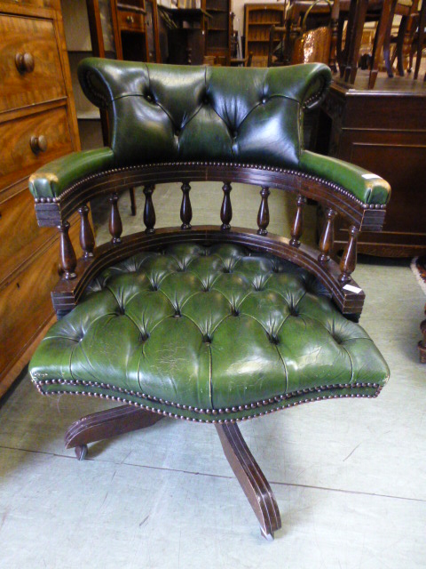 A green leather swivel office chair