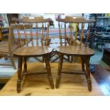 A pair of modern pine spindle back chair