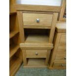 A pair of modern oak bedside cabinets