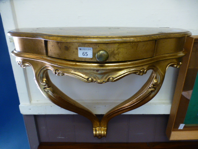 A reproduction gilt wall mounted console